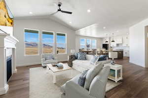 Grand living room with, ceiling fan, lofted ceiling, and hardwood / wood-style floors