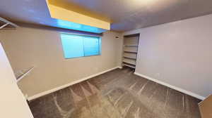 Unfurnished bedroom featuring carpet and a textured ceiling