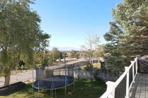 View of yard featuring a mountain view and a trampoline