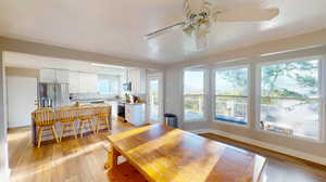 Dining space with light hardwood / wood-style floors and ceiling fan