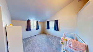 Bonus room featuring carpet flooring and lofted ceiling