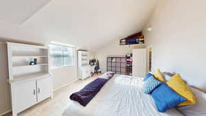 Carpeted bedroom with lofted ceiling