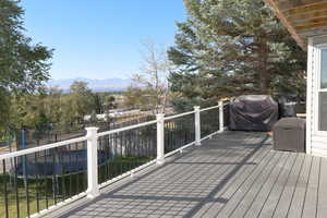 Deck with a mountain view and a grill