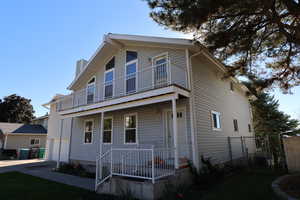 View of front of home featuring a balcony and a garage