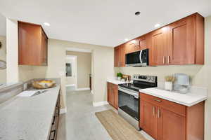 Gallery kitchen with new LG appliances (all included), new kitchen cabinetry, new granite countertops.  Tile flooring.