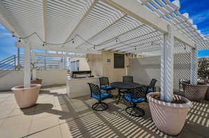 Rooftop patio with seating and barbecue area for entertainment.