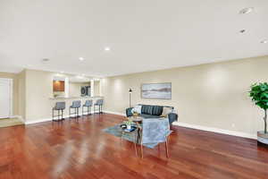 Living/dining area.  Open kitchen facing living/dining area and large windows.