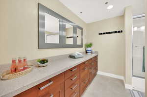 Owner's suite bathroom with spacious vanity top, tile flooring, large suite.