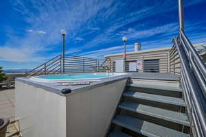 Rooftop entertainment area with hot tub.