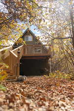 Front view of property featuring a wooden deck