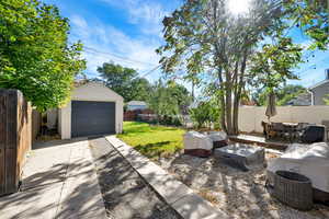 View of patio / terrace with an outdoor structure and a garage