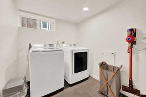 Laundry room with tile patterned floors and separate washer and dryer