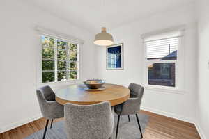 Dining area with wood-type flooring