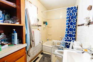 Full bathroom featuring shower / bathtub combination with curtain, tile walls, toilet, vanity, and tile patterned flooring