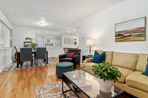 Living room featuring ornamental molding, hardwood / wood-style floors, and a healthy amount of sunlight