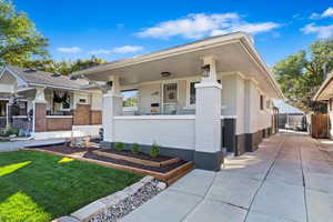 View of front of home with a porch and a front yard