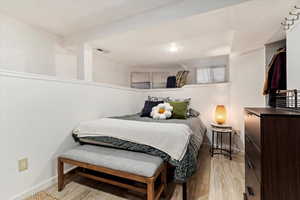 Bedroom with light hardwood / wood-style floors