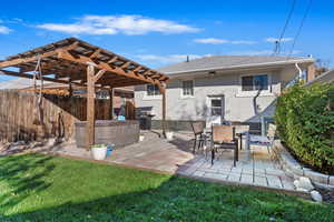 Exterior space with a patio, a lawn, and a pergola