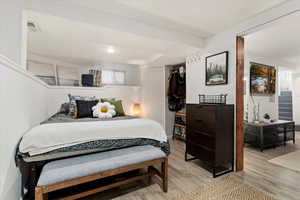 Bedroom with light hardwood / wood-style floors