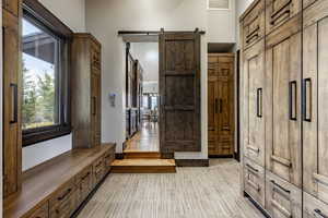 Mudroom featuring a barn door and light hardwood / wood-style flooring