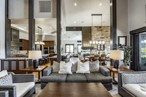 Living room with a chandelier and a towering ceiling