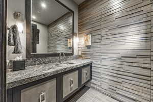 Bathroom featuring tile patterned flooring and vanity