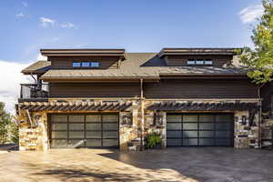 View of front of house with a balcony and a garage