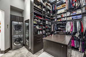 Walk in closet featuring stacked washer / dryer