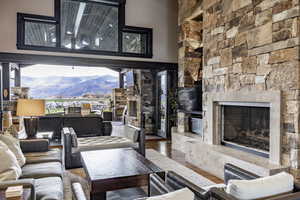 Living room with a fireplace and hardwood / wood-style floors