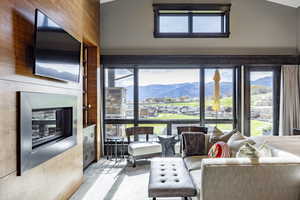 Living room with wood walls and lofted ceiling