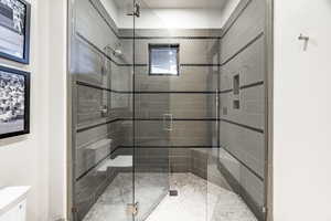 Bathroom with a shower with door and toilet