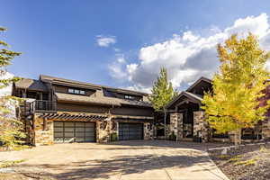 View of front of property featuring a balcony and a garage