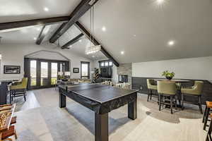 Playroom with french doors, light hardwood / wood-style flooring, high vaulted ceiling, and beam ceiling