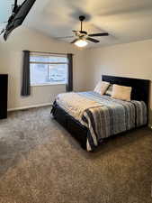 Bedroom featuring dark carpet and ceiling fan