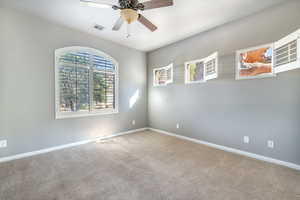 Carpeted empty room with ceiling fan