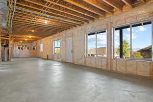 Miscellaneous room featuring gas water heater and concrete floors