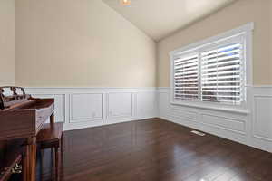 Interior space with dark wood-type flooring and vaulted ceiling