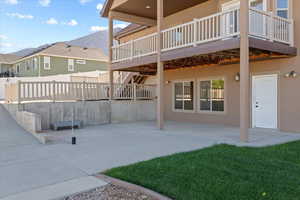 Rear view of property featuring a patio area and a deck with mountain view