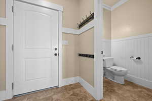 Bathroom with ornamental molding and toilet