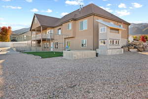 Back of house featuring a mountain view and a patio area