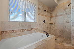 Bathroom featuring separate shower and tub