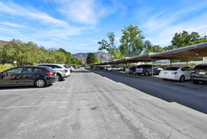 View of parking featuring a mountain view and a carport