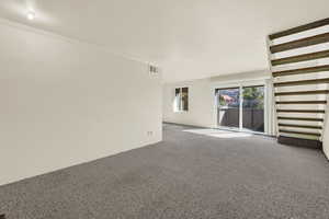 Unfurnished living room featuring carpet floors