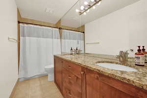 Loft primary suite bathroom with double sinks