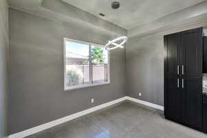 Unfurnished dining area featuring a chandelier