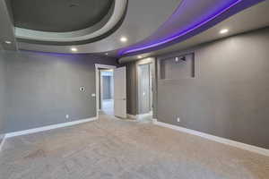 Carpeted empty room with a raised ceiling