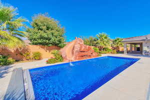 View of pool with a patio and pool water feature