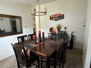 Carpeted dining room with a textured ceiling