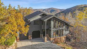 View of front of property with a mountain view and a garage