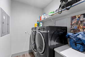 laundry room near mudroom and garage, with pocket door to primary closet